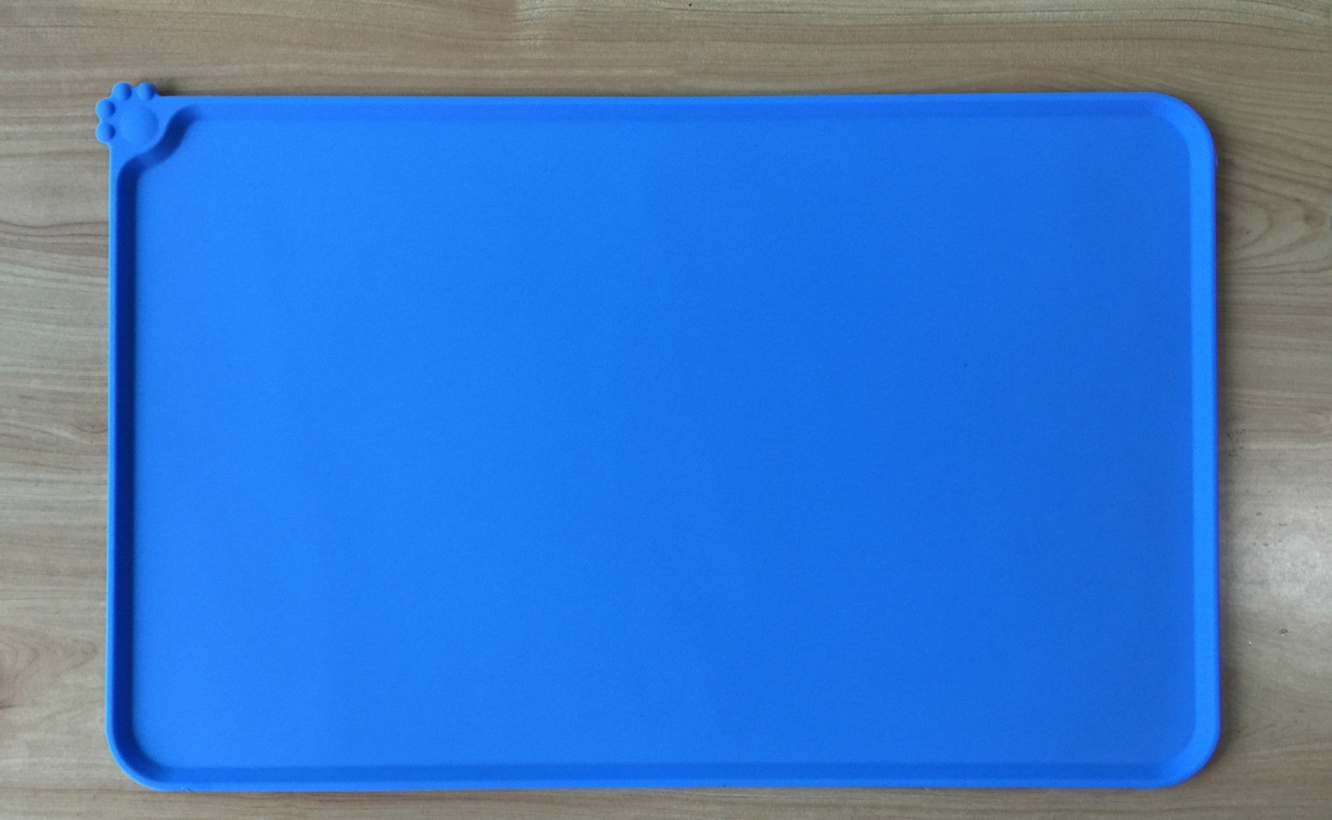 Blue pet feeding mat holding food and water bowls arranged neatly for pets  