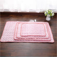 Cargar la imagen en la vista de la galería, Stack of three pink pet cooling mats of different sizes displayed on wooden floor
