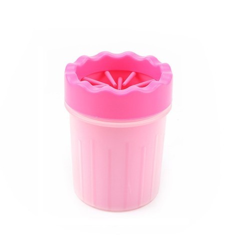 Pink silicone dog paw washer upright on white background