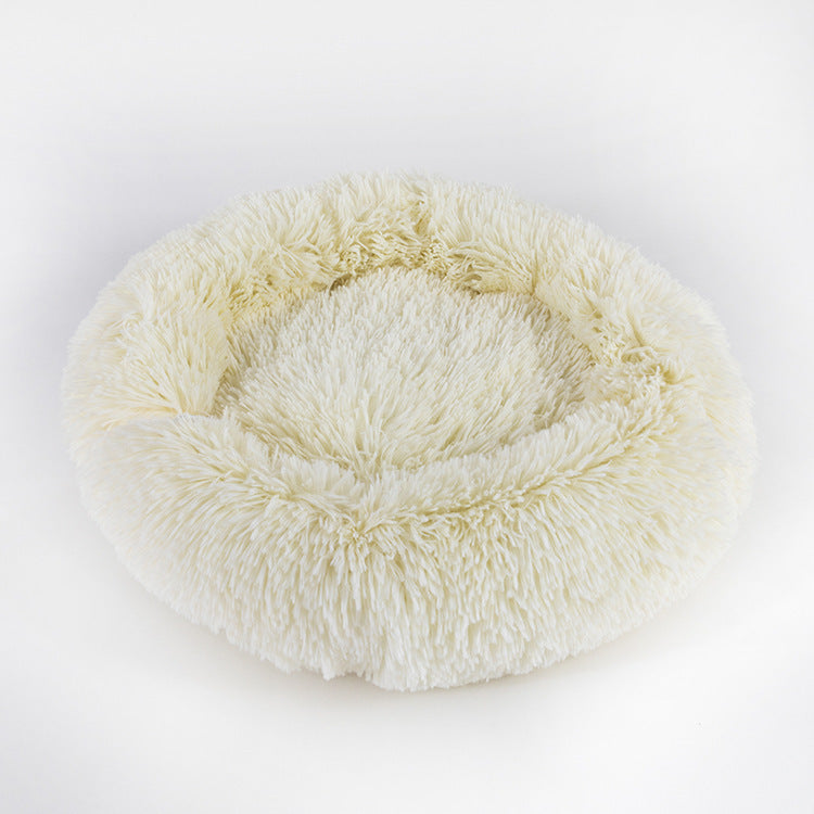 Cream colored plush round pet bed with shaggy faux fur texture