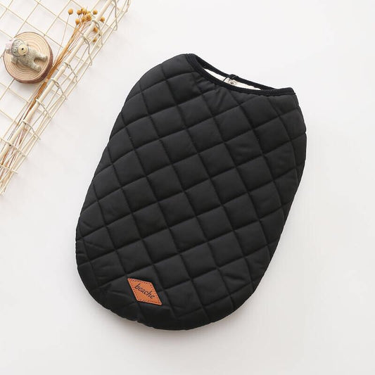 Black quilted dog vest laid flat showing diamond stitching and leather logo patch