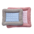Load image into Gallery viewer, Two striped quilted cooling pet beds stacked, smaller blue bed on top of larger pink bed.

