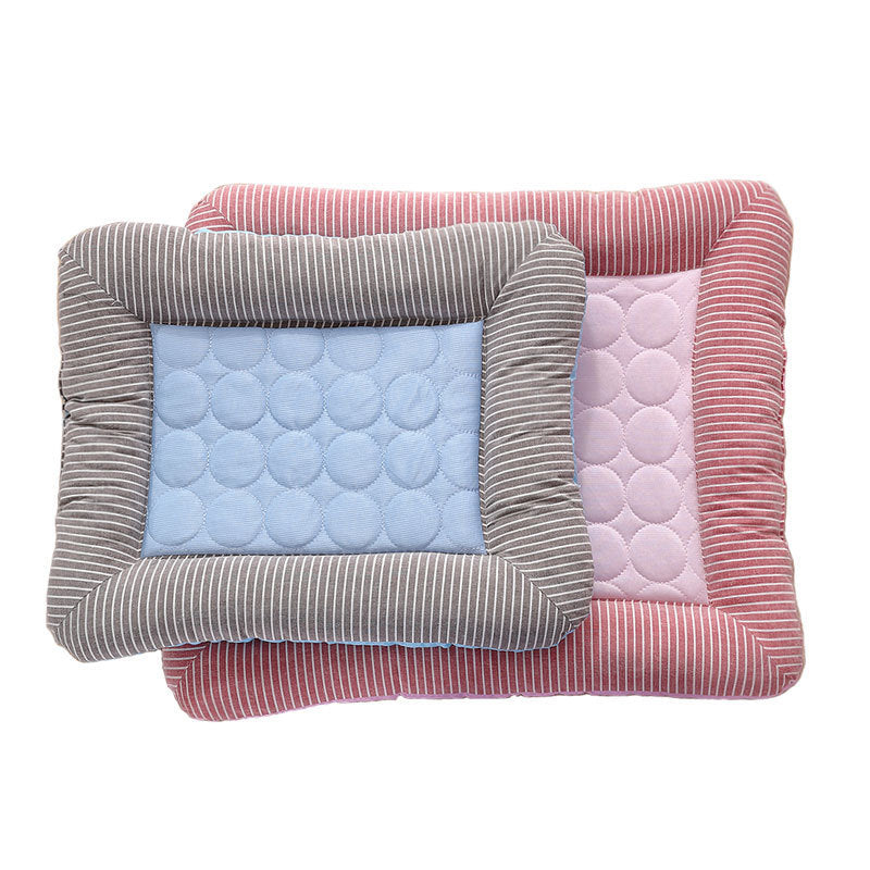 Two striped quilted cooling pet beds stacked, smaller blue bed on top of larger pink bed.