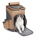 Cargar la imagen en la vista de la galería, Tan portable trolley pet backpack with cat stepping out of open front entry door
