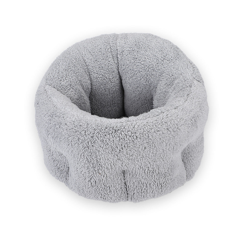 Gray plush round pet bed shown isolated on white background