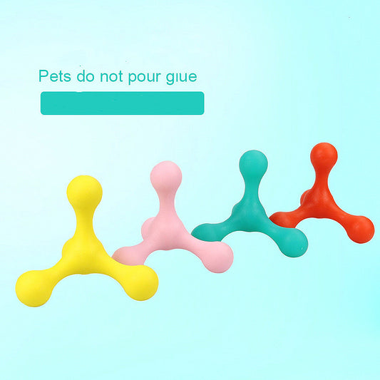 Four dog chew toys in yellow, pink, turquoise, and orange colors arranged in a row