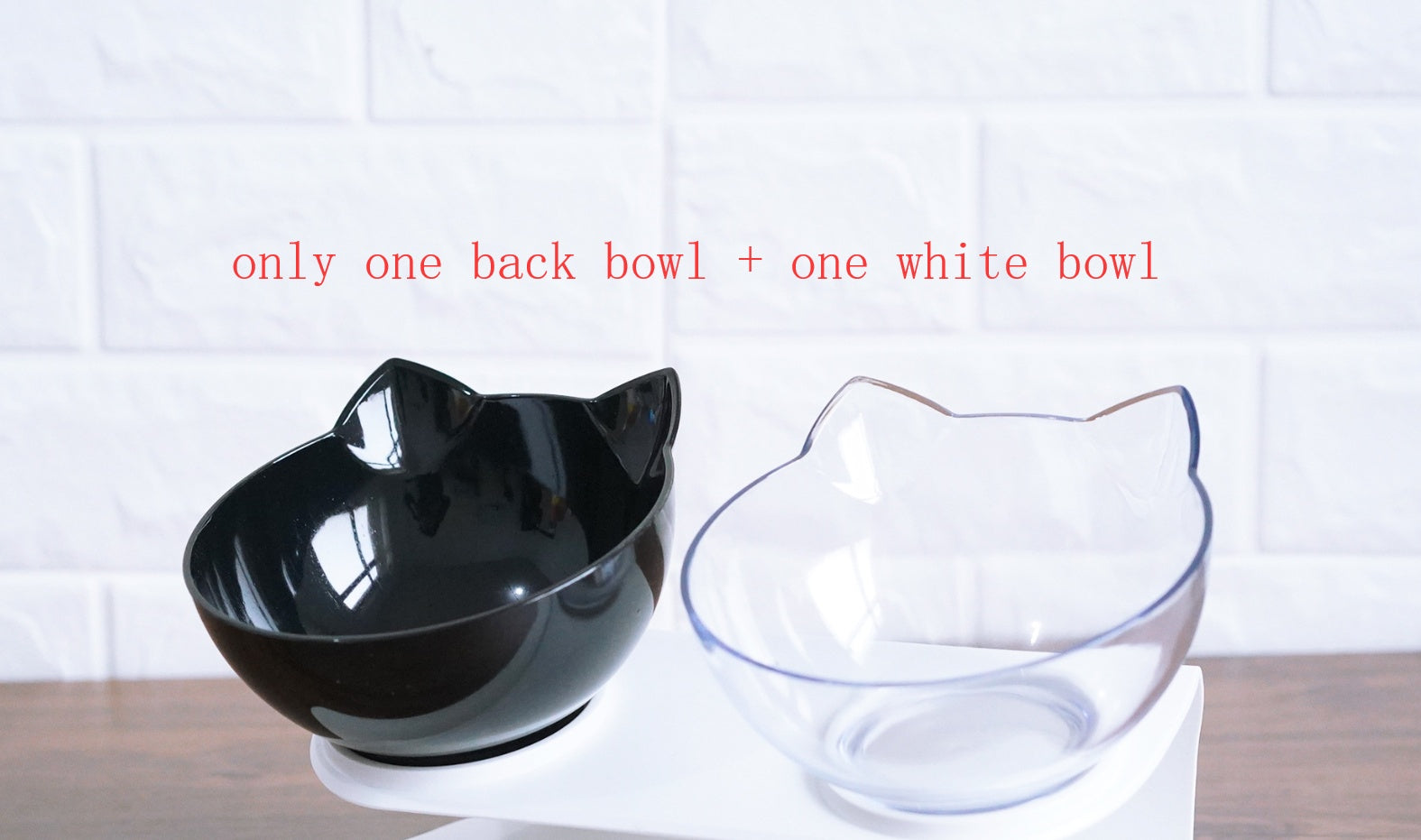 Mixed set of one black cat ear bowl and one white cat ear bowl on elevated white stand