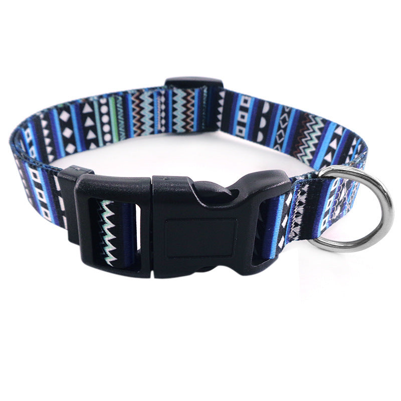 Close-up of blue geometric patterned dog collar with buckle and metal D-ring