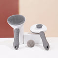Load image into Gallery viewer, Two pet grooming brushes displayed with detachable heads and a ball of collected pet hair
