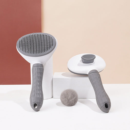 Two pet grooming brushes displayed with detachable heads and a ball of collected pet hair