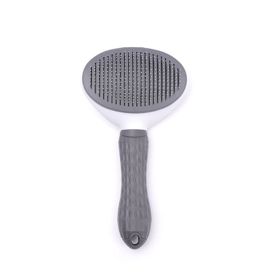 Top view of a grey and white detachable pet grooming brush with metal bristles