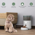 Cargar la imagen en la vista de la galería, Dog sitting next to automatic pet feeder showing customizable meal schedule, portion control, and voice interaction icons
