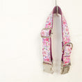Load image into Gallery viewer, Pink floral dog collar hanging by metal buckle on wall hook
