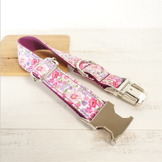 Pink floral dog leash showing metal clasp and adjustable strap on white surface