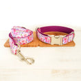 Load image into Gallery viewer, Matching pink floral dog collar and leash set on wooden boards
