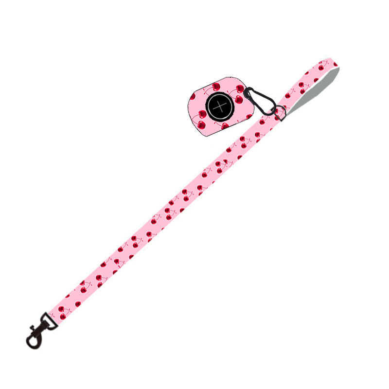 Pink cherry patterned dog leash with attached dog poop bag holder clip