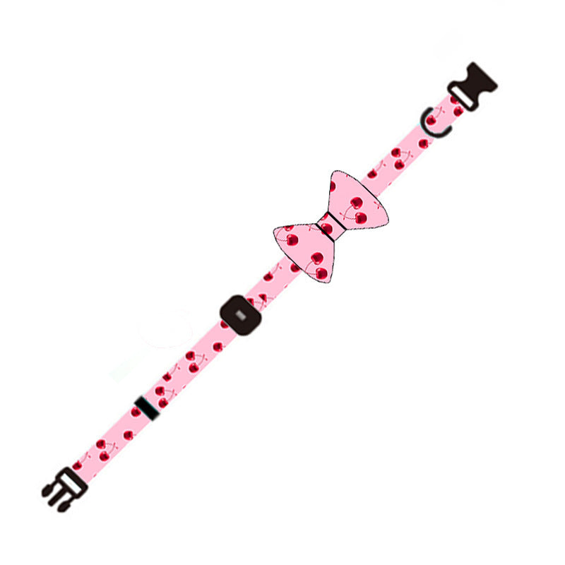 Close-up of pink cherry patterned adjustable dog collar with bowknot accessory
