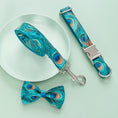 Load image into Gallery viewer, Rolled up peacock print leash alongside adjustable collar and bow tie on pale green background
