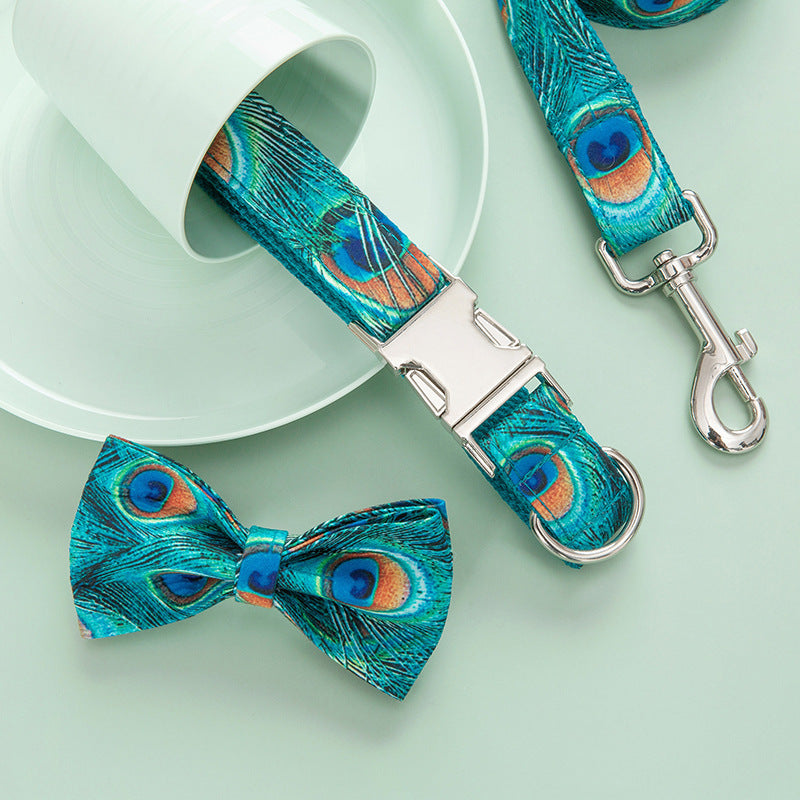 Peacock print collar and bow tie near white teacup on light green surface