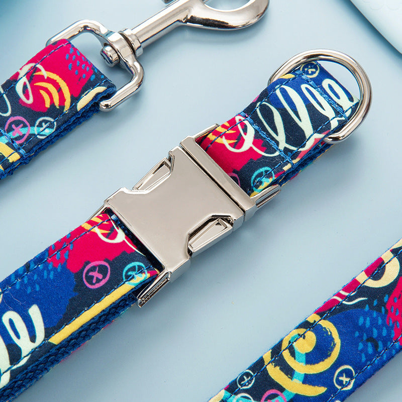 Close-up of metal quick-release buckle on vibrant dog collar with graffiti design