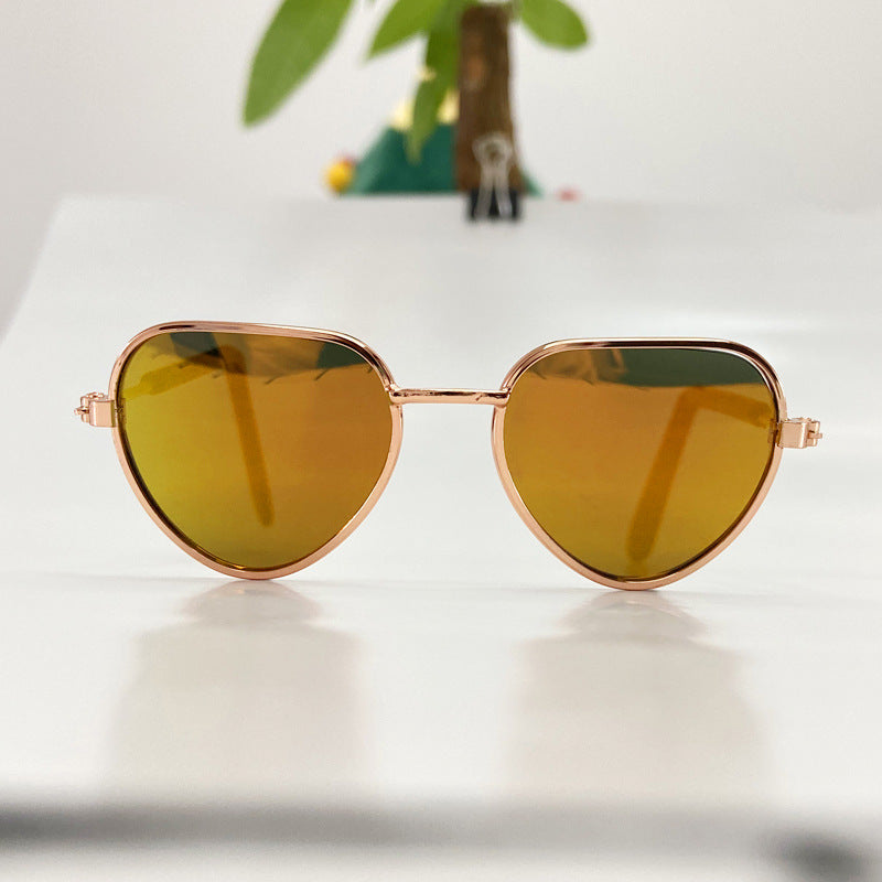Aviator cat sunglasses with yellow tinted lenses and rose gold frame on white background