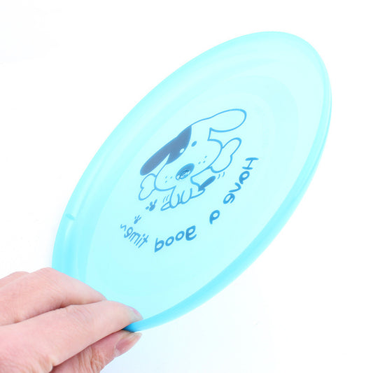 Hand holding light blue flexible dog flying disc with dog graphic