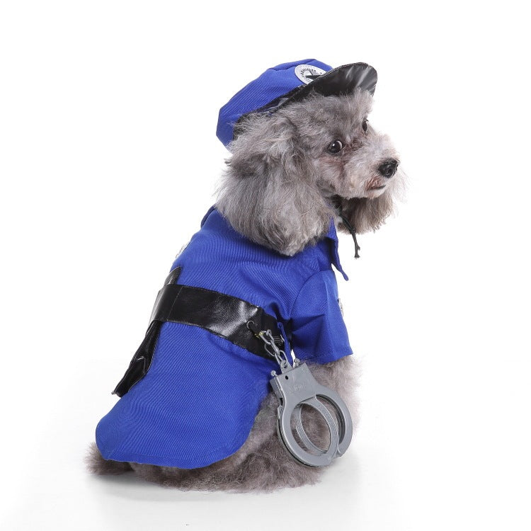 Small gray dog in blue police costume with black belt and handcuffs, wearing matching hat, sitting and looking to the side