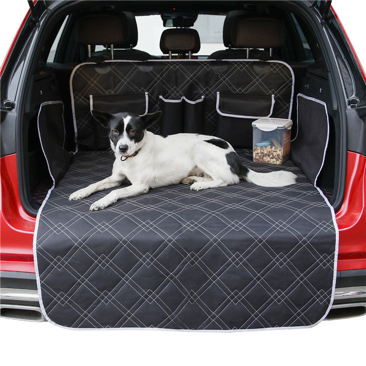 Dog lying on car trunk mat made of black Oxford cloth with pet food container beside