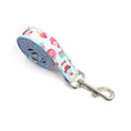 Load image into Gallery viewer, Rolled-up dog leash featuring blue fabric with fun cupcake, ice cream, and candy design

