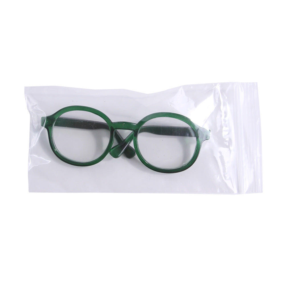 Green round plastic cat glasses in clear plastic packaging