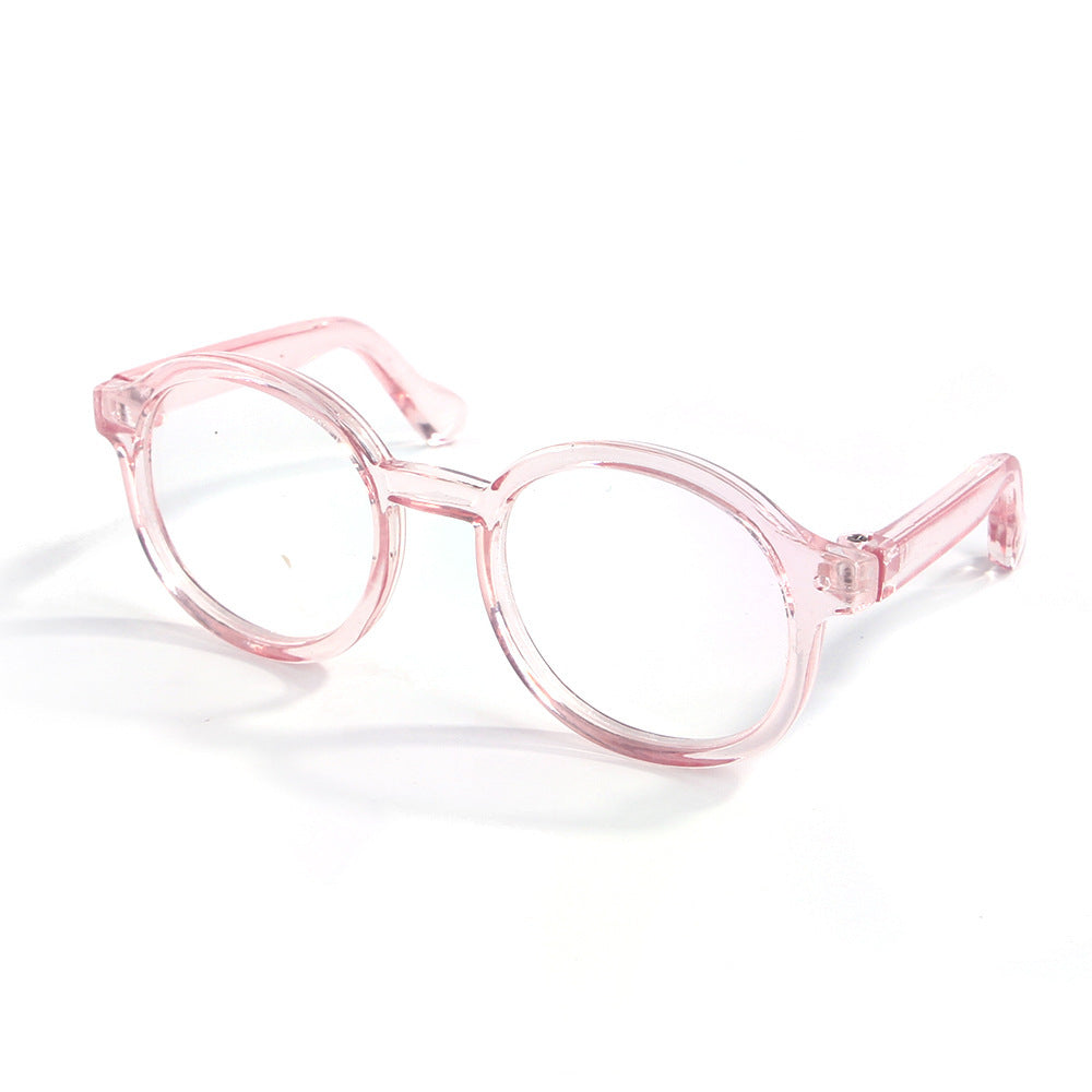 Pink transparent round plastic cat glasses on white background