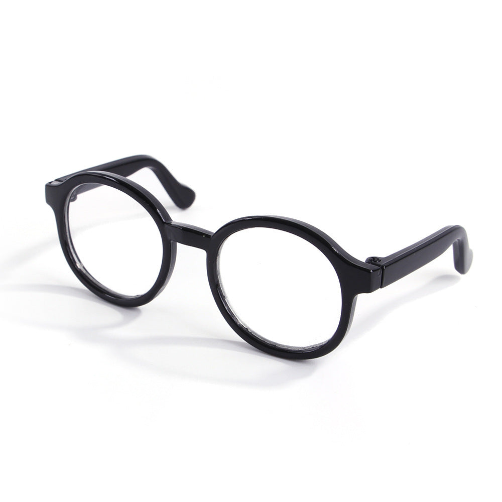 Black round plastic cat glasses on white background