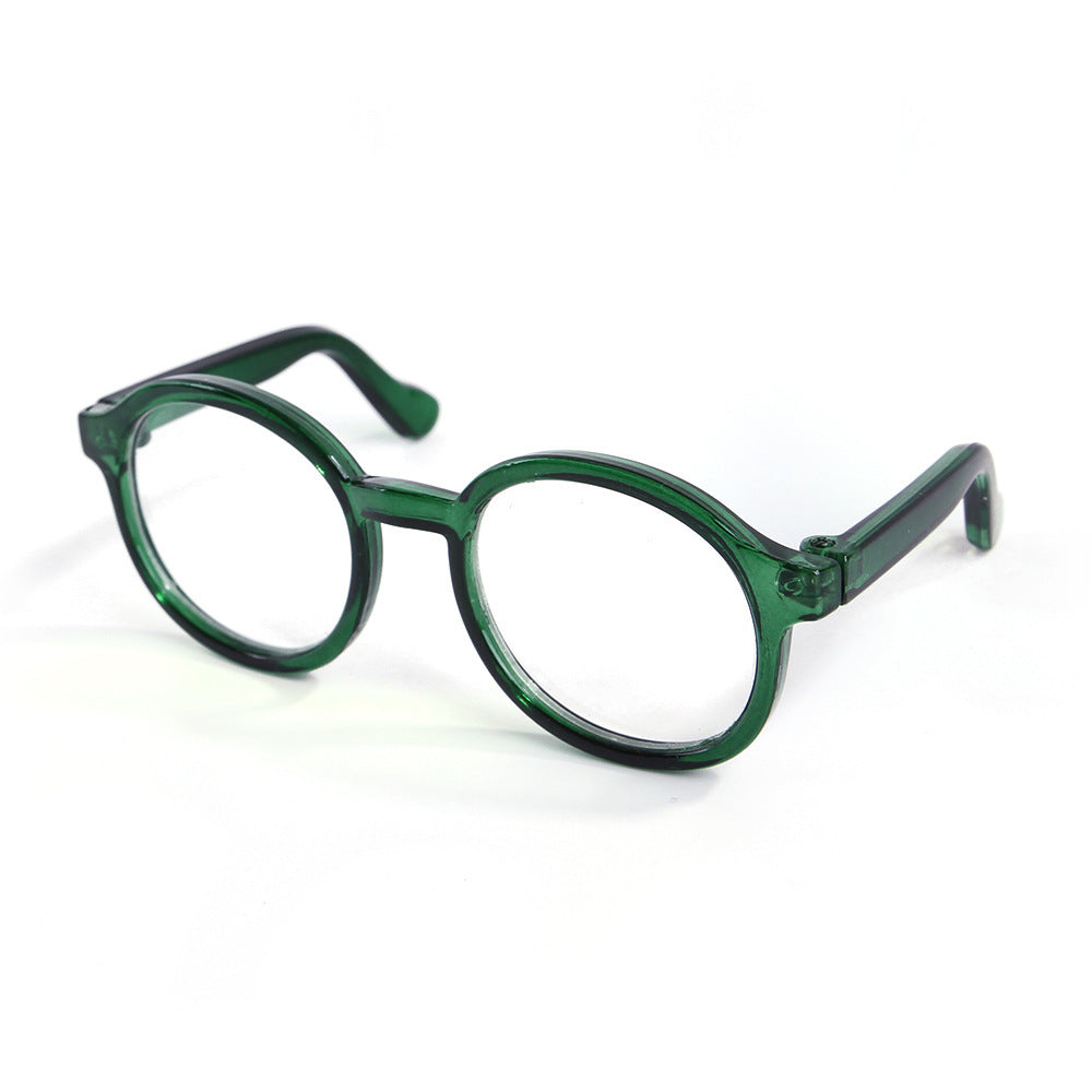 Green transparent round plastic cat glasses on white background