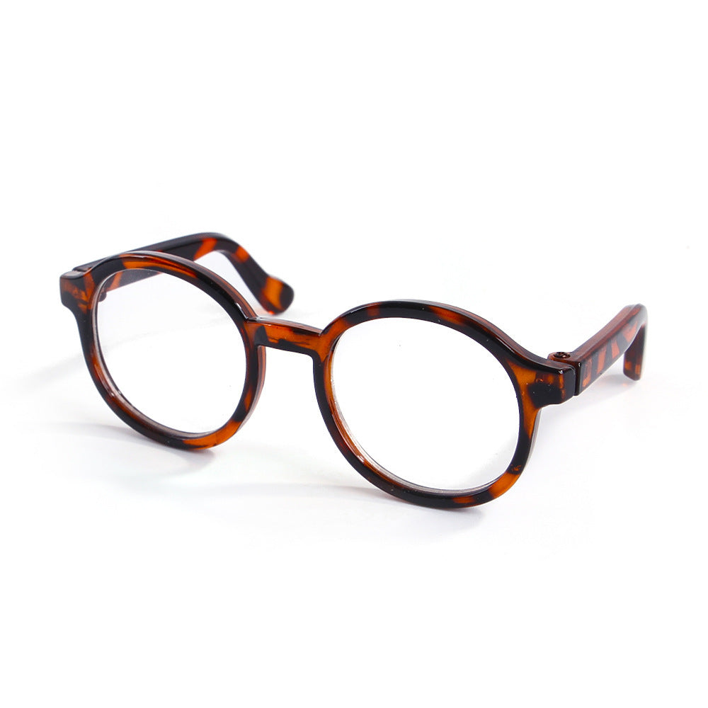 Brown leopard print round plastic cat glasses on white background