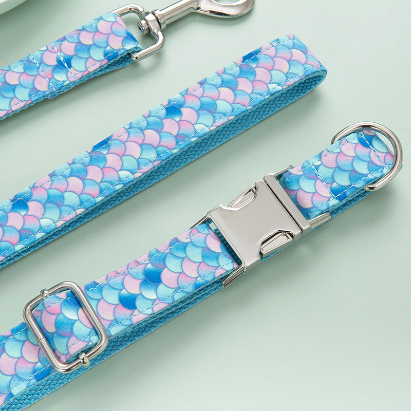 Close-up of leash and collar showing metal clip and adjustable buckle with mermaid scale design