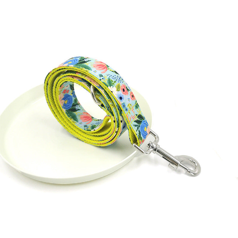 Rolled floral dog leash arranged on white ceramic plate