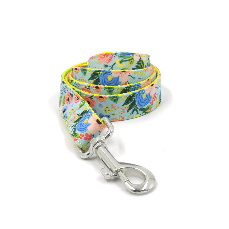 Rolled floral dog leash showing vibrant flower pattern and metal snap