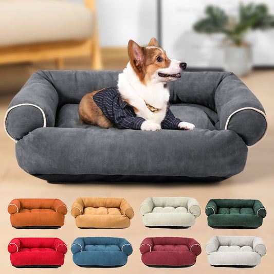 Corgi dog lying comfortably in a plush dark gray velvet pet sofa bed with white piping