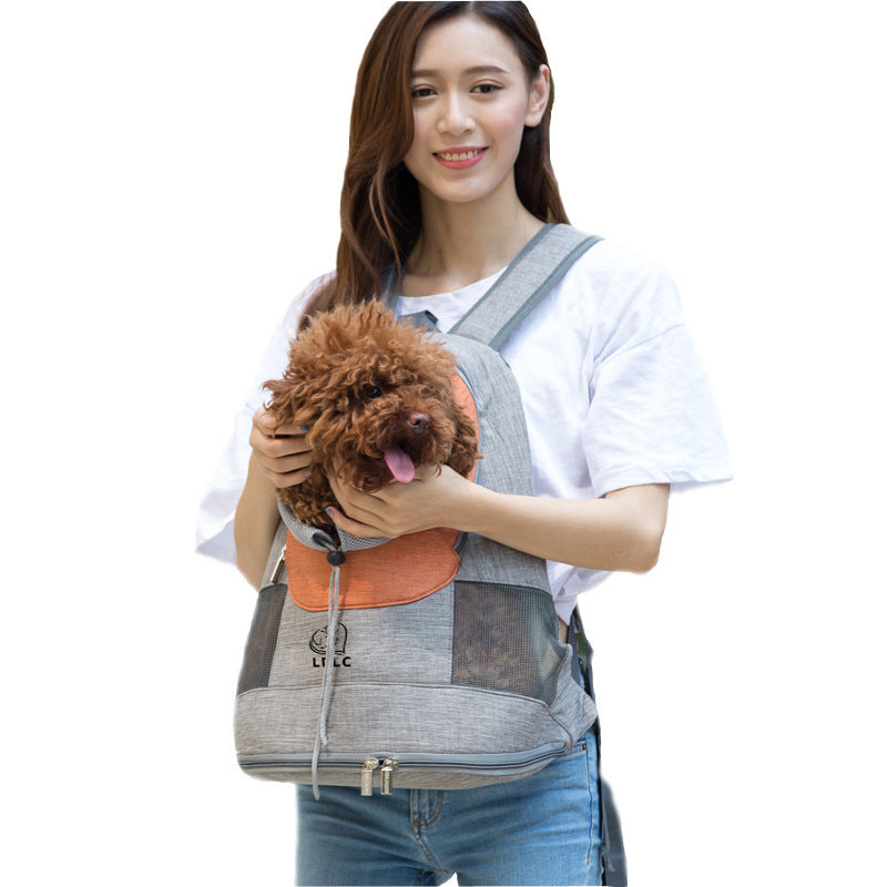 Woman happily holding dog’s head coming out of orange and gray backpack pet carrier
