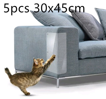 Five clear claw protector pads stuck on gray sofa corner with cat reaching