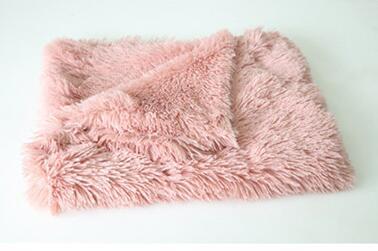 Pink plush pet blanket with fluffy texture folded