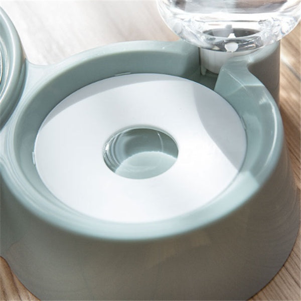 Close-up of water refill mechanism on green automatic pet feeding station