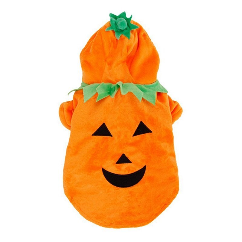 Top-down flat lay of pumpkin dog costume showing bright orange plush fabric and green stem applique on hood