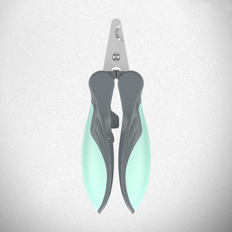Closed green and gray pet nail clipper viewed from above on gray background