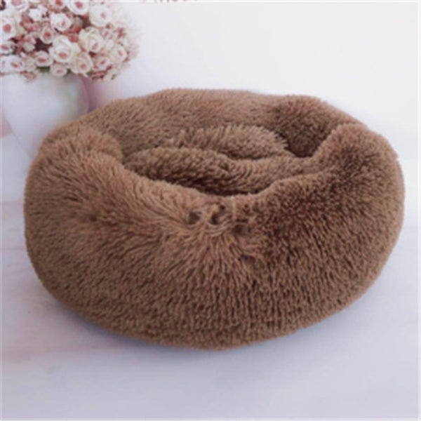 Brown round plush pet bed with smooth, soft texture on white background