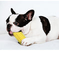 Load image into Gallery viewer, Black and white dog chewing yellow corn molar chew toy
