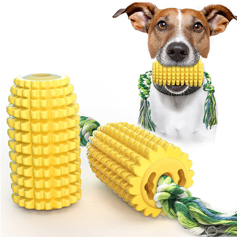 Yellow corn-shaped chew toy with attached rope and dog holding it