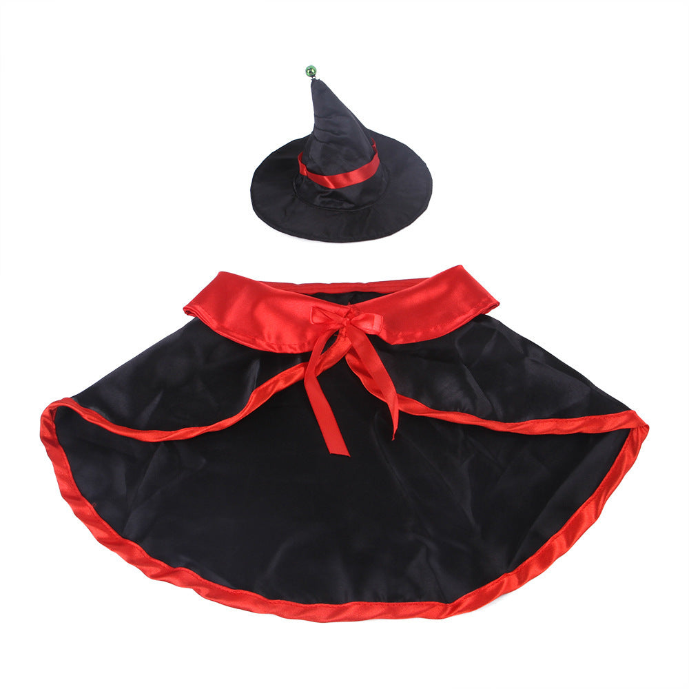 Black and red satin witch cape laid out with matching black witch hat with red ribbon and green bell