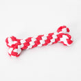 Load image into Gallery viewer, Close-up of red and white braided cotton rope dog chew toy bone shape on white background
