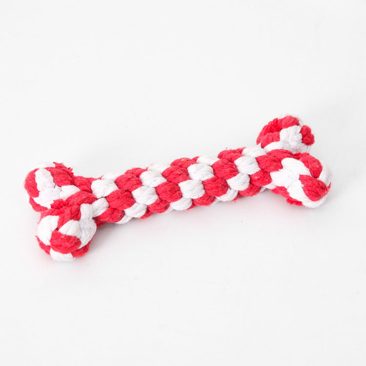 Close-up of red and white braided cotton rope dog chew toy bone shape on white background